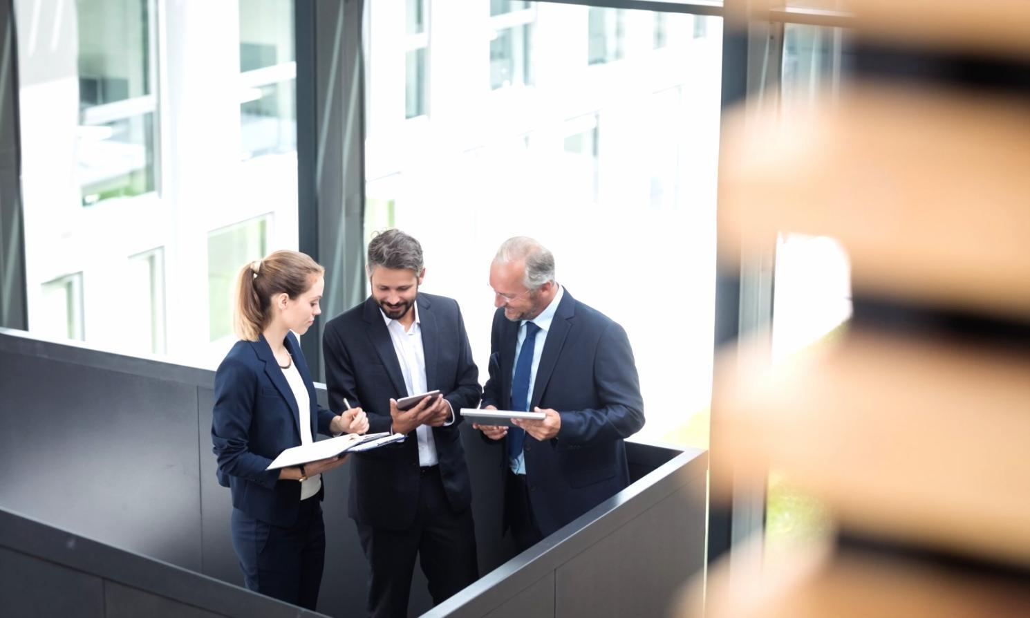 Students analyzing financial charts and investment data during practical learning session